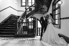 The groom and the bride posing near the stairs at The Bvlgari Hotel Shanghai